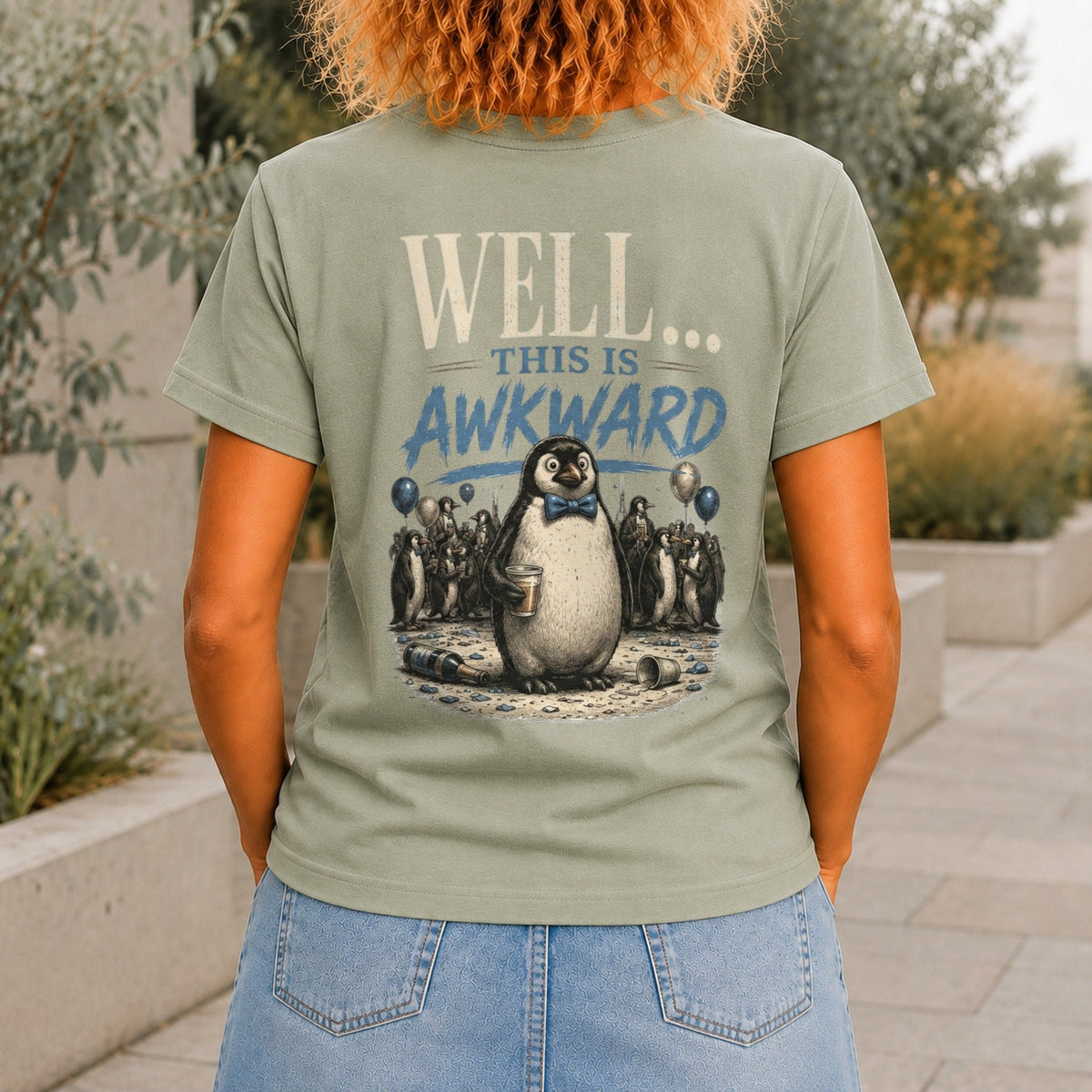 Well... This Is Awkward graphic printed on the back of a sage KRED Threads premium tee