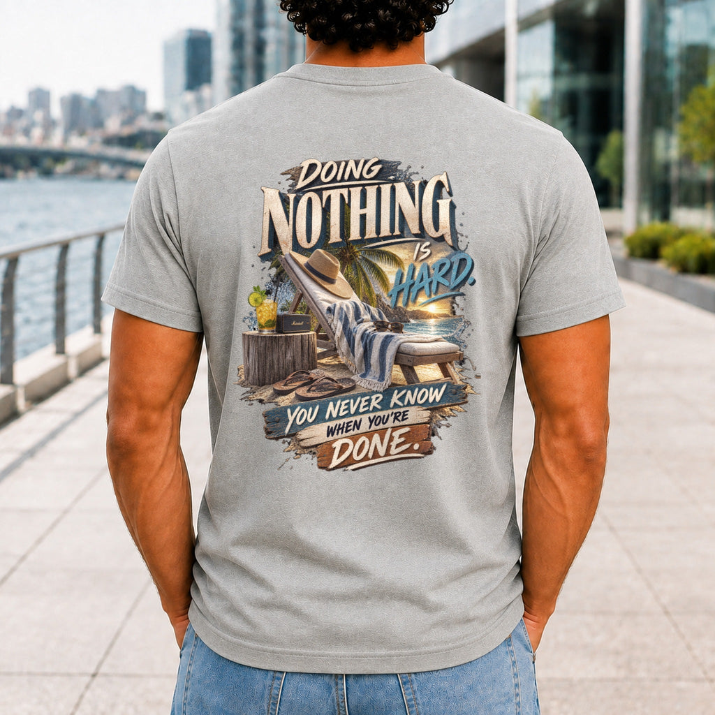 Doing Nothing Is Hard graphic printed on the back of an athletic heather KRED Threads premium tee