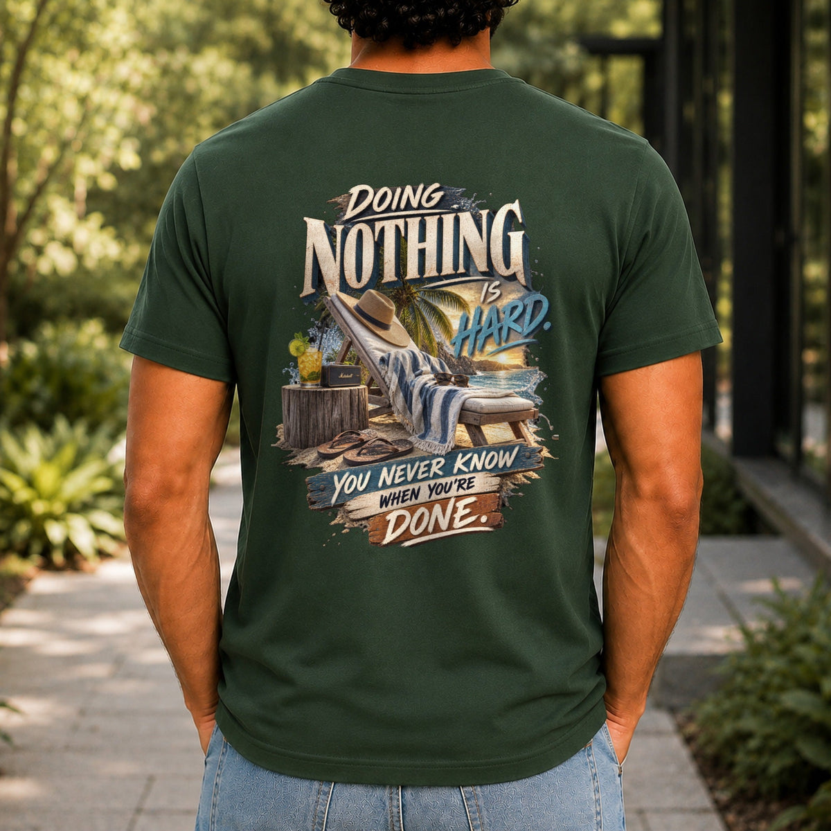 Doing Nothing Is Hard graphic printed on the back of a forest green KRED Threads premium tee