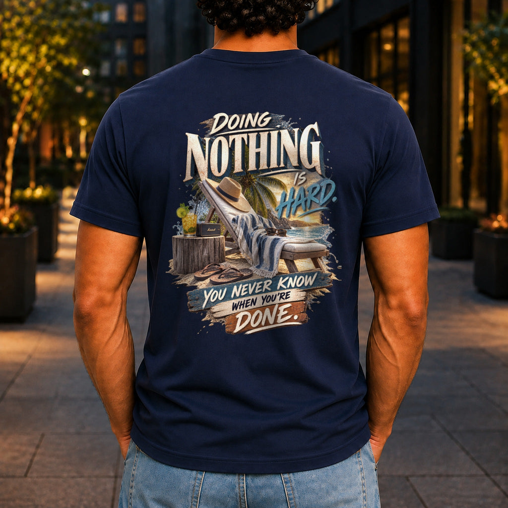 Doing Nothing Is Hard graphic printed on the back of a navy KRED Threads premium tee