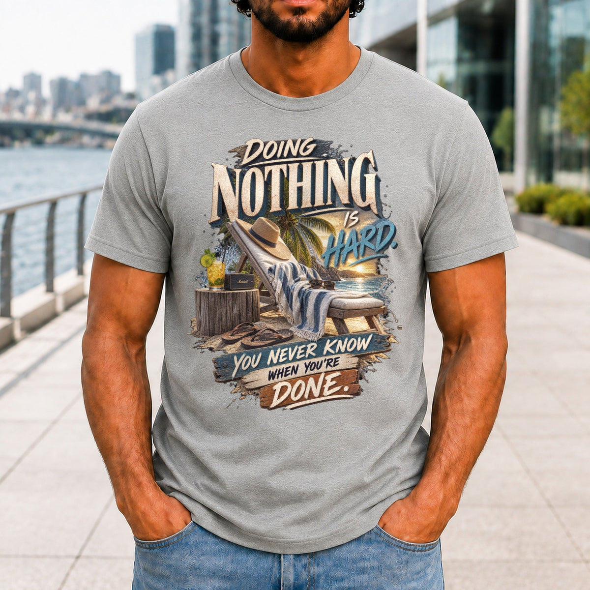 Doing Nothing Is Hard graphic printed on the front of an athletic heather KRED Threads premium tee