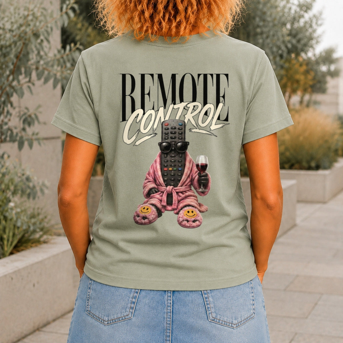 Remote Control graphic printed on the back of a sage KRED Threads premium tee