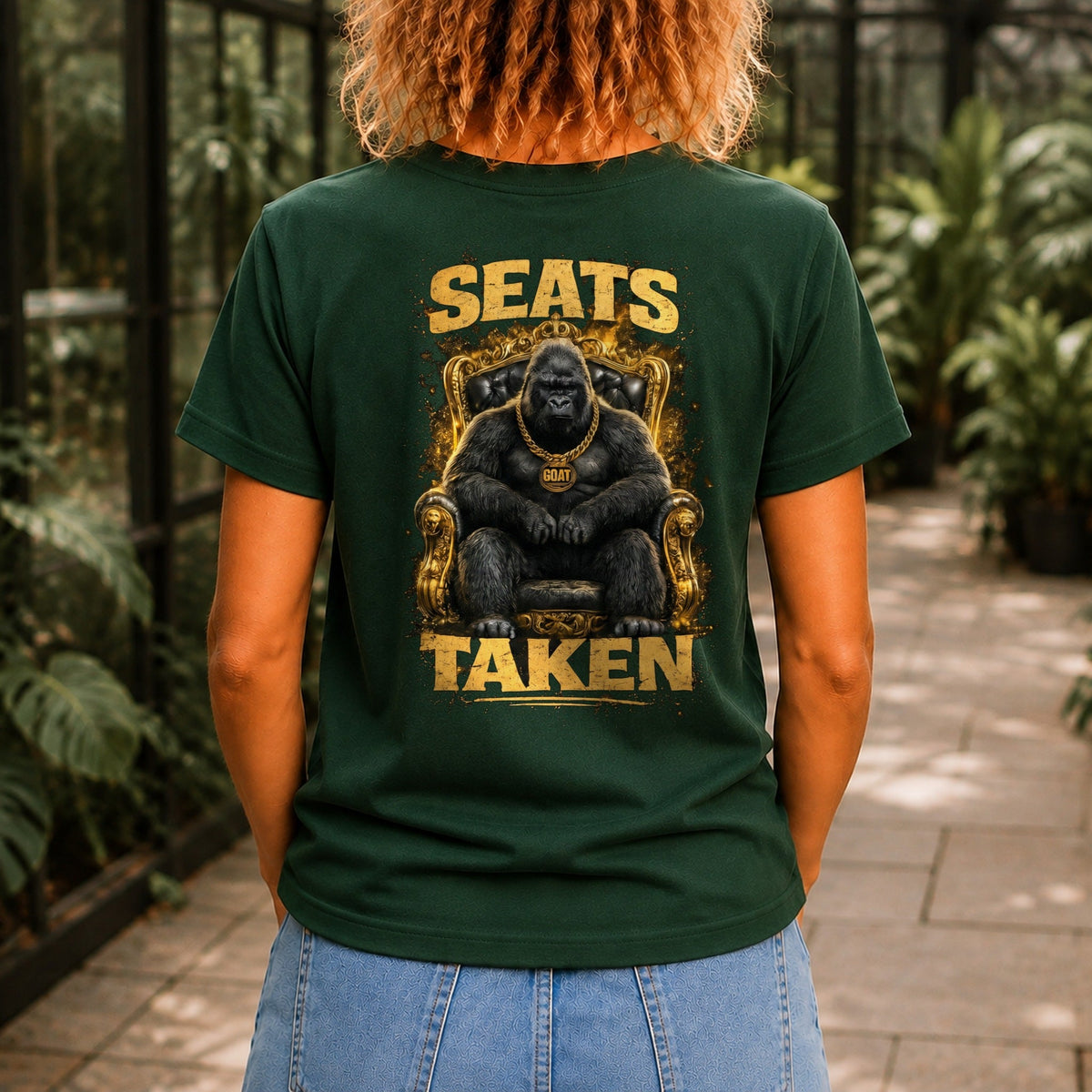 Seats Taken graphic printed on the back of a forest green KRED Threads premium tee