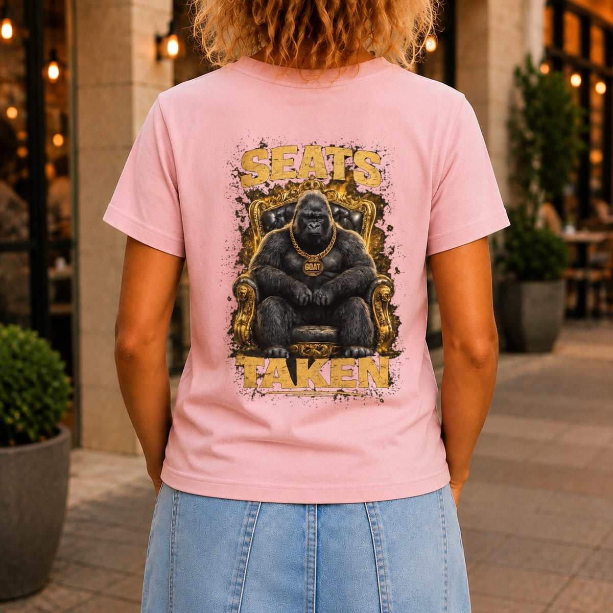 Seats Taken graphic printed on the back of a pink KRED Threads premium tee