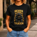 Seats Taken graphic printed on the front of a black KRED Threads premium tee