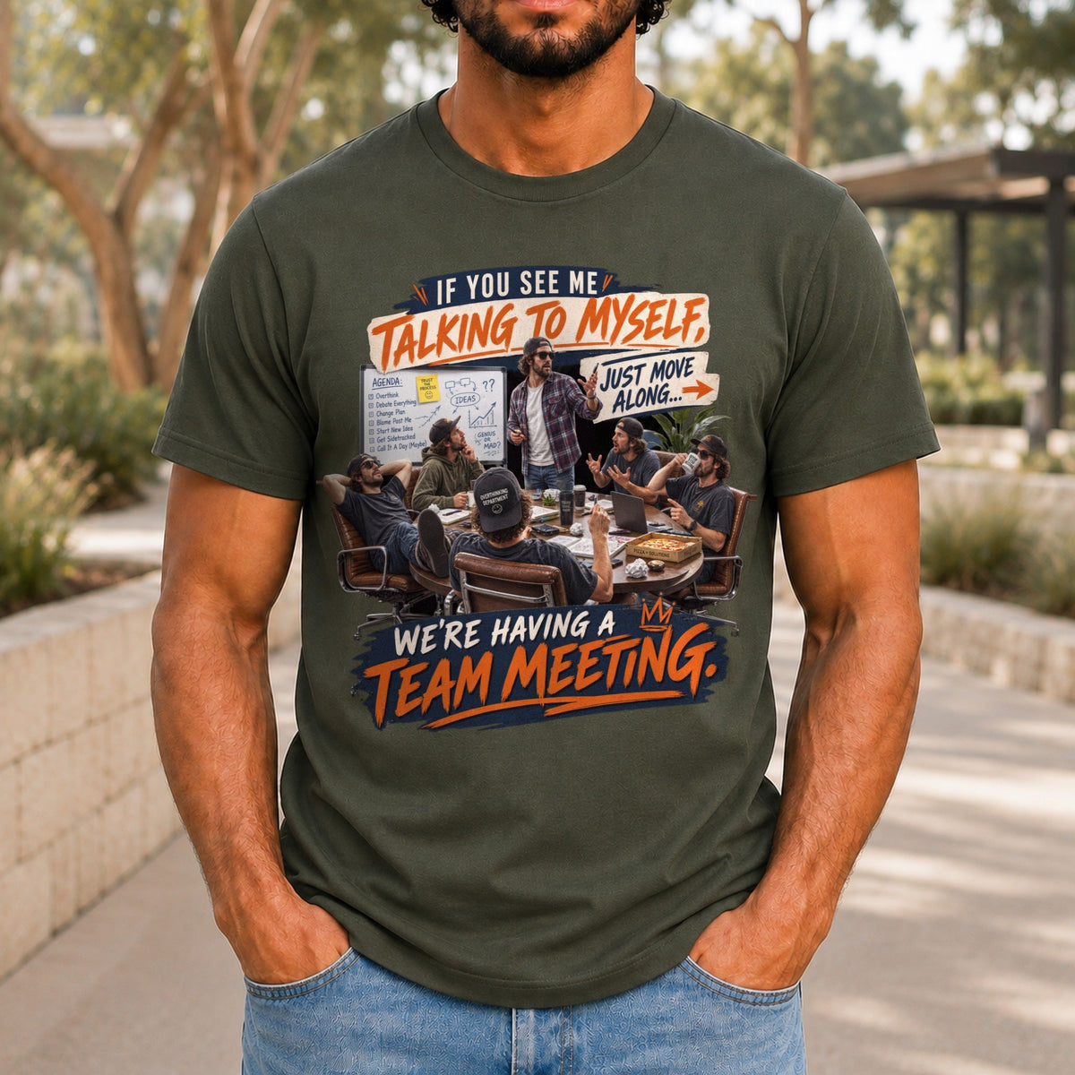 We're Having A Team Meeting graphic printed on the front of an army KRED Threads premium tee