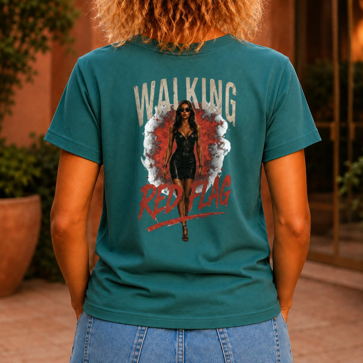 Walking Red Flag graphic printed on the back of a jade KRED Threads premium tee